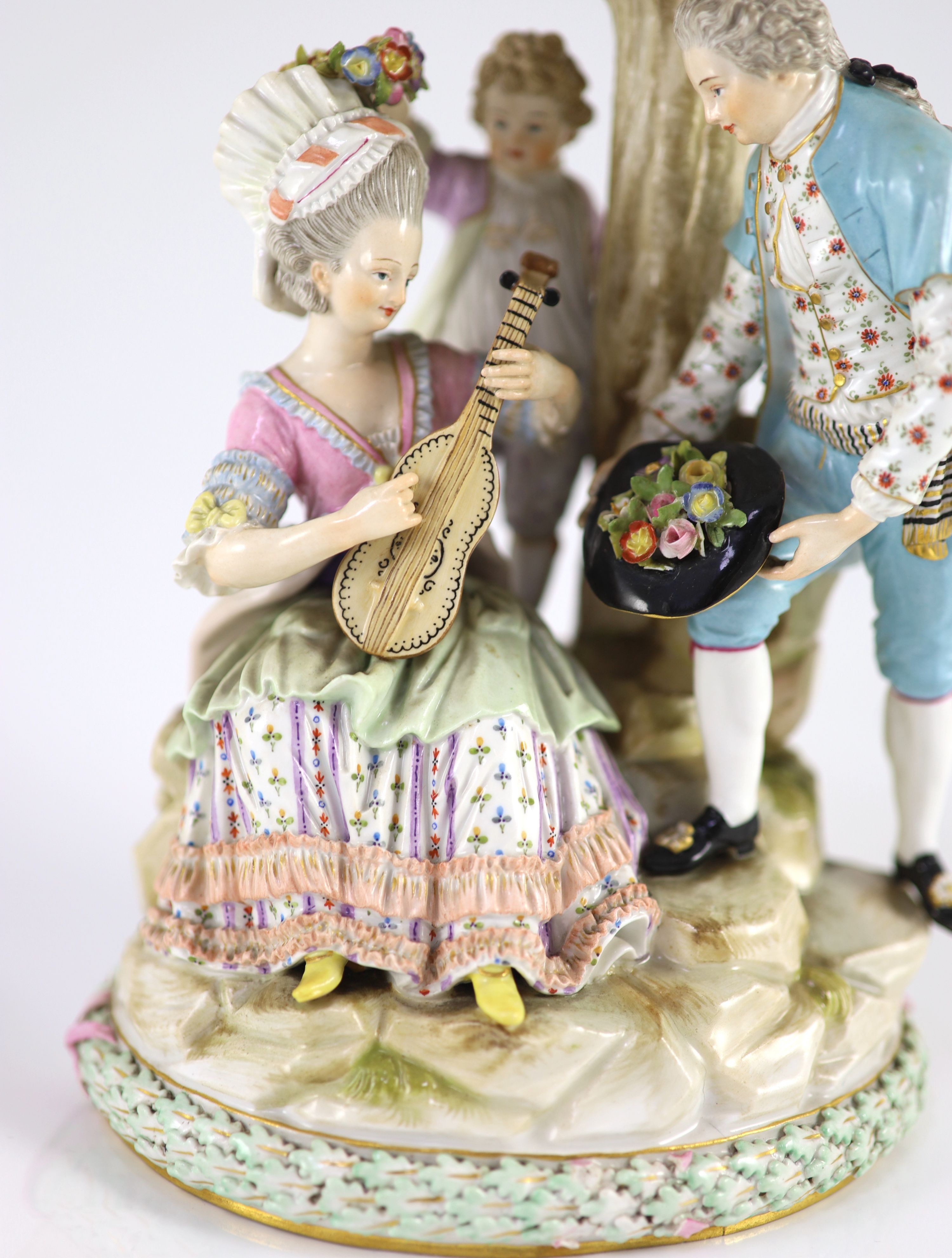 A Meissen group of flower pickers, 19th century, 26 cm high, losses to tree